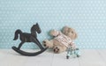 Old wooden toy horse rocking chair, teddy bear and blue vintage Royalty Free Stock Photo