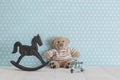 Old wooden toy horse rocking chair, teddy bear and blue vintage Royalty Free Stock Photo