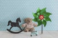 Old wooden toy horse rocking chair, teddy bear, pinwheel and blu Royalty Free Stock Photo