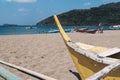 An old wooden traditional banca or outrigger boat lying in the sand dragged inland by the owner. At Calayo beach, Nasugbu, Royalty Free Stock Photo