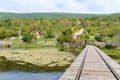 Old wooden train bridge and mill at gacka river in central croatia Royalty Free Stock Photo