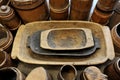 Old wooden troughs among the wooden tubs. Royalty Free Stock Photo