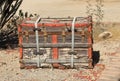 Old wooden trunk sitting on gravel Royalty Free Stock Photo