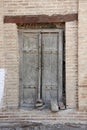 Old wooden tumbledown door in the Central Asian style Royalty Free Stock Photo