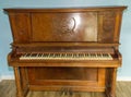 Old wooden upright grand piano black and white keys with detailed sconce Applique on late 1800s instrument, worn, broken, damaged Royalty Free Stock Photo