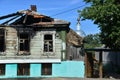 The old wooden village house after fire and church