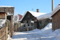 Old wooden village house with outbuildings in the winter