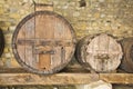 Old wooden vine barrels in an old italian cellar with stone floo