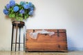 Old wooden vintage chest, vase with blue  flowers Royalty Free Stock Photo