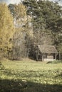 Old wooden vintage rural abandoned house, country yard on the fringe of the forest of the picturesque forest in autumn Royalty Free Stock Photo