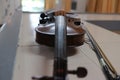 An old wooden violin instrument placed on a selective focus table. Royalty Free Stock Photo