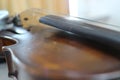 An old wooden violin instrument placed on a selective focus table. Royalty Free Stock Photo