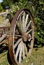 Old wooden wagon wheel as a backyard decoration Royalty Free Stock Photo