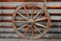 Old wooden wagon wheel on a wooden wall Royalty Free Stock Photo