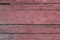 Old wooden wall from boards with peeling red paint with cracks. rough surface texture Royalty Free Stock Photo