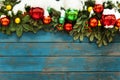 The old wooden wall is decorated with ice branches, red balloons and snow on the street. Old grunge wooden blue board with Royalty Free Stock Photo