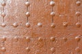 Old wooden wall with metal rivets painted orange Royalty Free Stock Photo