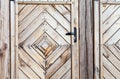 Old wooden wall texture or background with copy space. boards diagonally in a diamond shape. Detail of the door.