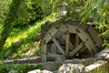 Old wooden water pumping wheel on the river Royalty Free Stock Photo