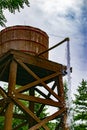 An old wooden water tank from which water comes out Royalty Free Stock Photo