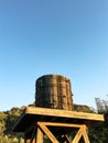 Old wooden water tower on a blue sky. Royalty Free Stock Photo