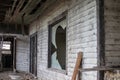 Old wooden weathered dilapidated abandoned two story house front windows busted out Royalty Free Stock Photo