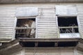 Old wooden weathered dilapidated abandoned two story house looking up at windows Royalty Free Stock Photo