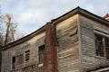 Old wooden weathered dilapidated abandoned two story house roof and chimney Royalty Free Stock Photo