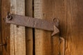 Old wooden weathered door with metal rusty latch. Royalty Free Stock Photo