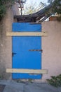 Old wooden weathered door painted blue closed with wood panels