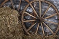 Old wooden wheel on a hay