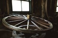 Old wooden wheel of the horse cart in the ancient forge. Royalty Free Stock Photo