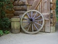 Old wooden wheel and two old wooden barrels Royalty Free Stock Photo