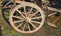 old wooden wheel of a wagon for transport with woody spokes Royalty Free Stock Photo