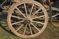 old wooden wheel of a wagon for transport with woody spokes Royalty Free Stock Photo