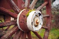 Paint on a red wooden wheel weathers. Royalty Free Stock Photo