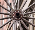 Old wooden wheel, wooden spokes, metal bolts Royalty Free Stock Photo