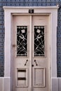 Old wooden white door with wrought iron details