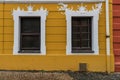 Old wooden white windows in old yellow building in Prague Royalty Free Stock Photo