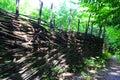 Old wooden wicker fence in the Ukrainian village close-up, hedge of the territory.