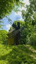 old wooden wildmill in the summer deciduous forest