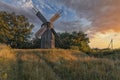 Old wooden windmill at dramatic sunset, historic outdoor background Royalty Free Stock Photo
