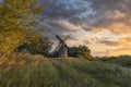 Old wooden windmill at dramatic sunset, historic outdoor background Royalty Free Stock Photo