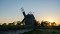 Old wooden windmill at dramatic sunset, historic outdoor background Royalty Free Stock Photo