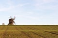 Old windmill by a farmers corn field Royalty Free Stock Photo