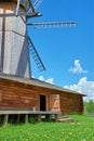 Old wooden windmill stands in field Royalty Free Stock Photo