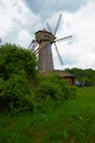 Old wooden windmill stands in field Royalty Free Stock Photo