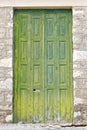 Old wooden window green shutters on stone wall