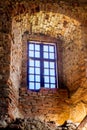 An old wooden window in an ancient castle in a brick wall_ Royalty Free Stock Photo