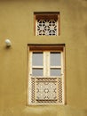 Old wooden window with beautiful decorations and carvings and Iranian motifs on it, thatched wall, Masouleh, Iran